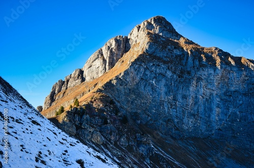 Hike up the Fronalpstock mountain in the canton of Glarus. Beautiful autumn atmosphere with the first snow in the Swiss Alps. Mountain panorama of the Mürtschenstock massif. High quality photo photo