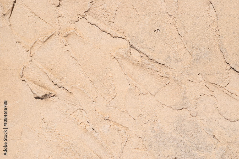 Textured sand surface with natural patterns visible Textured sand surface with natural patterns visible