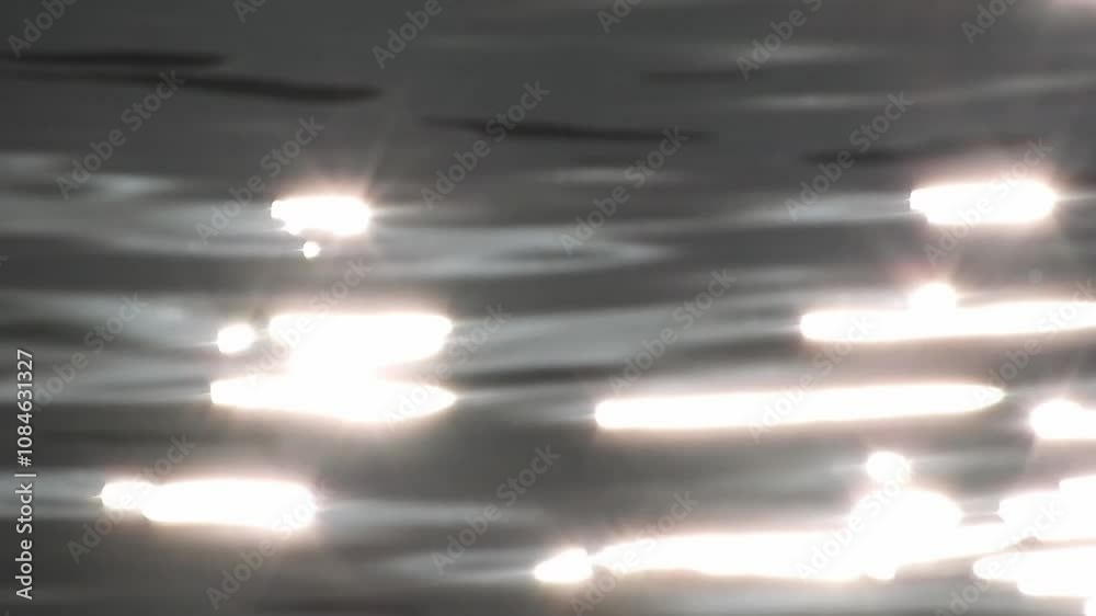 Sun shining glares on the water surface hd video. Bright sun refletions on the rippled river in the evening.
