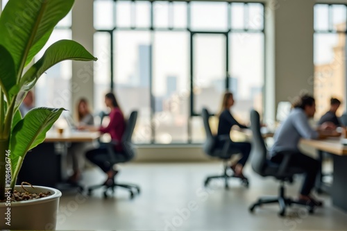 A group of individuals sitting together at a table in a bright room filled with greenery