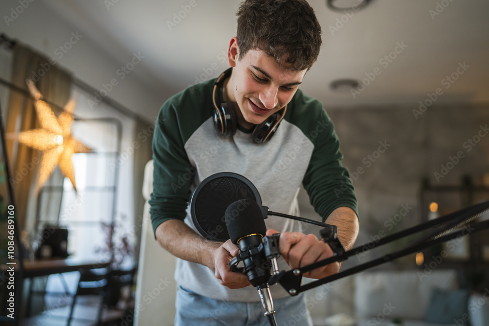 man blogger stand and prepare microphone for new video at home studio man blogger stand and prepare microphone for new video at home studio