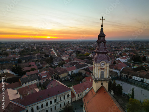  European bell tower with old red roof town in the background, Vršac, Serbia - aerial drone photo