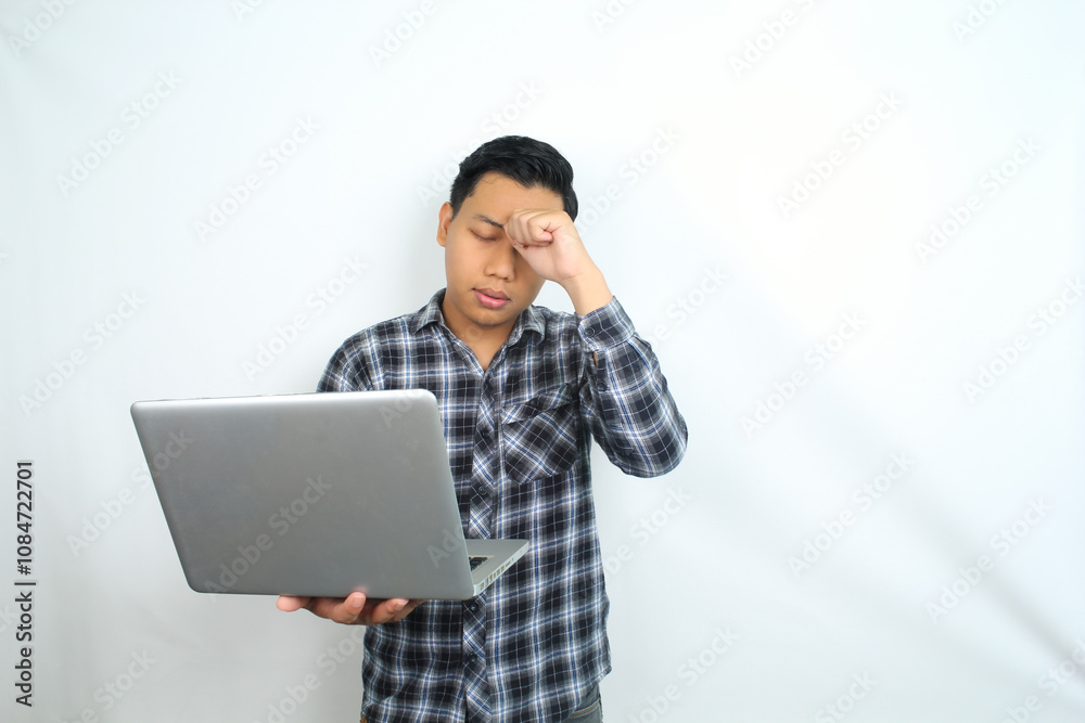 asian man feels dizzy or headache while holding laptop, exhaustion and unhealthy male overworked, isolated on white background asian man feels dizzy or headache while holding laptop, exhaustion and unhealthy male overworked, isolated on white background