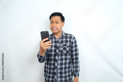 asian man angry using bad application on smartphone isolated on white wear casual shirt