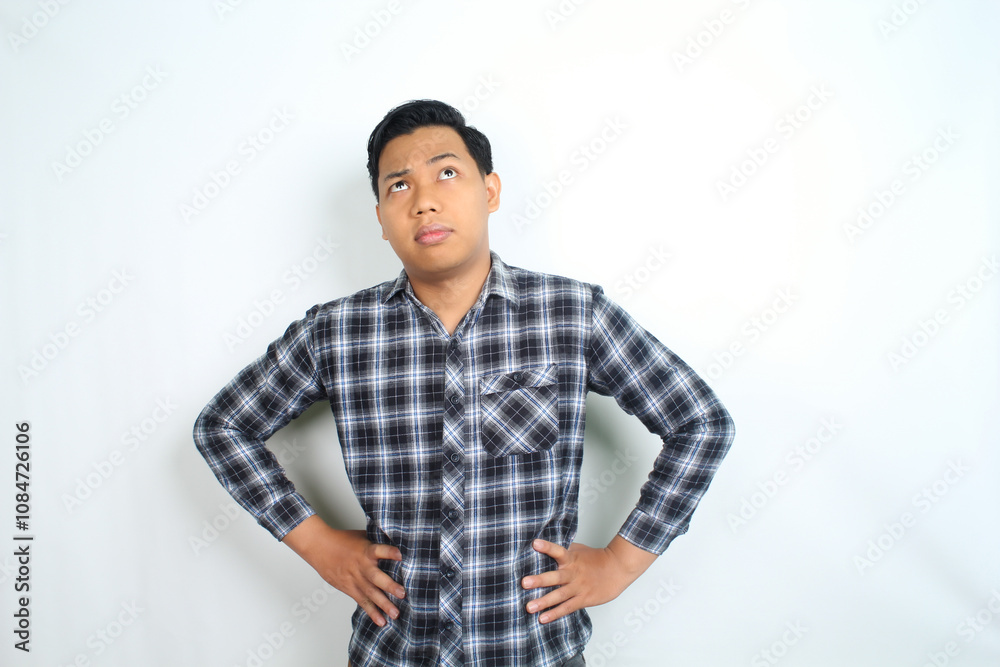 thoughtful asian man thinking idea with confused expression wearing casual shirt isolated on white thoughtful asian man thinking idea with confused expression wearing casual shirt isolated on white