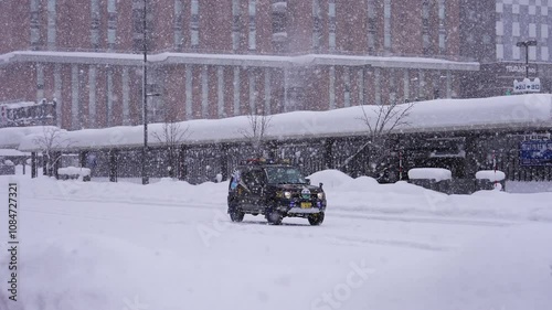 Japan, Hokkaido - Wakkanai city center covered in white snow in December, cars driving on snowy roads photo