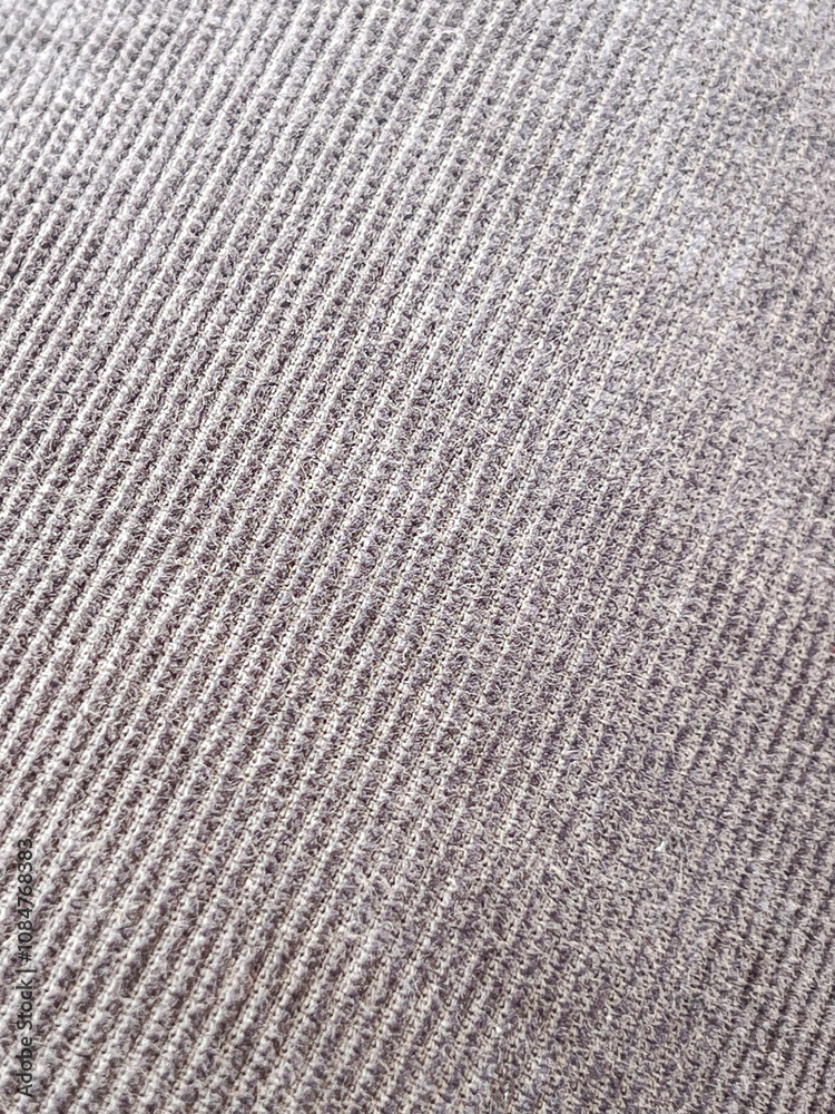 A detailed macro shot of gray corduroy fabric, showcasing its ridged pattern and textured surface. Perfect for design, fashion, or textile-focused projects. A detailed macro shot of gray corduroy fabric, showcasing its ridged pattern and textured surface. Perfect for design, fashion, or textile-focused projects.