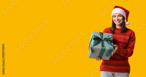 Young woman in Santa hat an...
