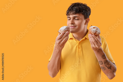 Young man with tasty muffin...