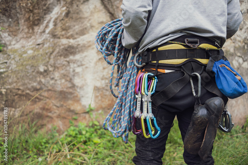 Close-up of a thigh climber with all equipment hanging on safety harness, prepared for rock climbing