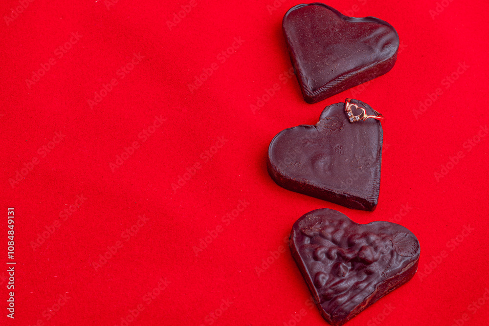Fototapeta premium Valentine's Day celebration composition, chocolate hearts on a red background