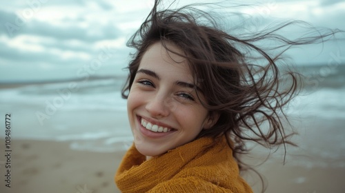A carefree woman smiling on a breezy beach day symbolizing joy and freedom