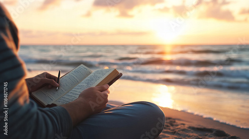 Enjoying a peaceful moment reading a book by the shore during sunset at the beach photo