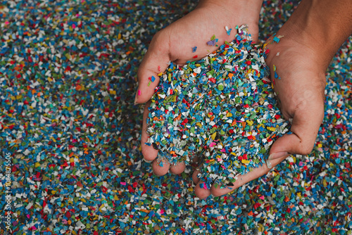 Hands hold clear white plastic pellets, raw materials for various manufacturing processes. These pellets are widely used in industries to produce products like packaging, bottles, and equipment parts.