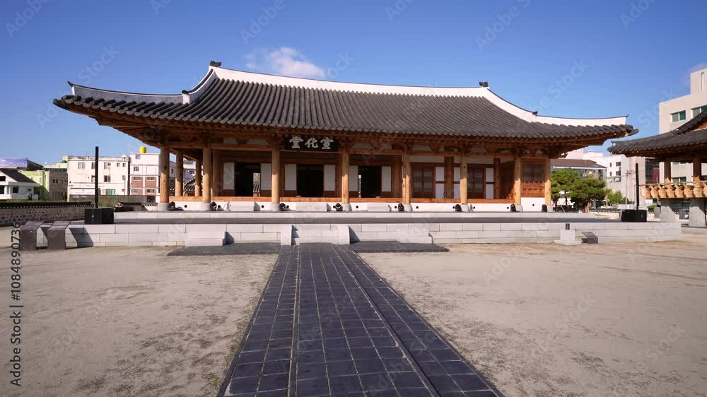 a traditional Korean pavilion with a tiled roof and wooden beams, situated in a courtyard with a stone pathway leading to its entrance, surrounded by a blend of traditional and modern architecture a traditional Korean pavilion with a tiled roof and wooden beams, situated in a courtyard with a stone pathway leading to its entrance, surrounded by a blend of traditional and modern architecture