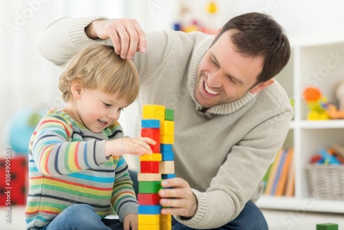 A father and his young son engage in a fun activity, stacking colorful blocks. The child focuses intently on the tower, while the father encourages him with a smile.