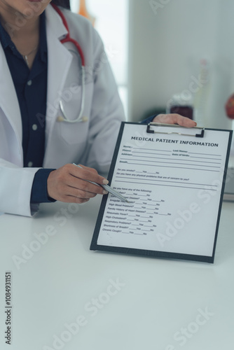 Medical Patient Information: A close-up shot of a healthcare professional's hand pointing to a medical patient information form, emphasizing the importance of accurate and complete data in healthcare.