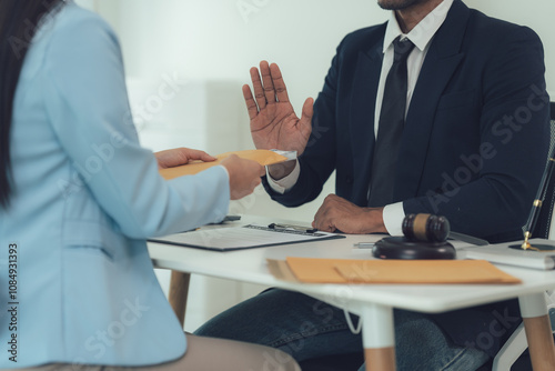 Refusal of a Bribe:  Lawyer rejecting a bribe offered by a client, emphasizing integrity and ethical conduct in legal practice.  A serious and dramatic scene in a professional office setting. photo