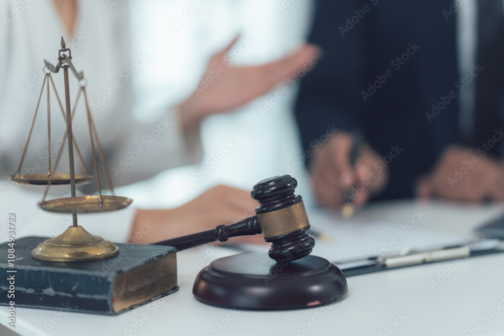 Justice and Order: A gavel and scales of justice, symbols of fairness and legal proceedings, stand on a table with a blurred background, a powerful visual representation of the legal system. Justice and Order: A gavel and scales of justice, symbols of fairness and legal proceedings, stand on a table with a blurred background, a powerful visual representation of the legal system.