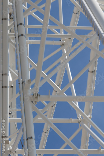 Close up of white metal girder detail on ferris wheel