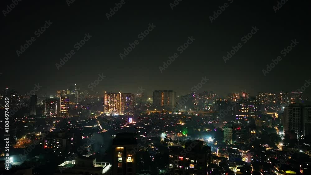 Drone pans left to reveal Mumbai’s lit-up cityscape, shimmering with festive lights and Diwali celebration. A vibrant aerial view capturing the joy and colors of the festival night Drone pans left to reveal Mumbai’s lit-up cityscape, shimmering with festive lights and Diwali celebration. A vibrant aerial view capturing the joy and colors of the festival night