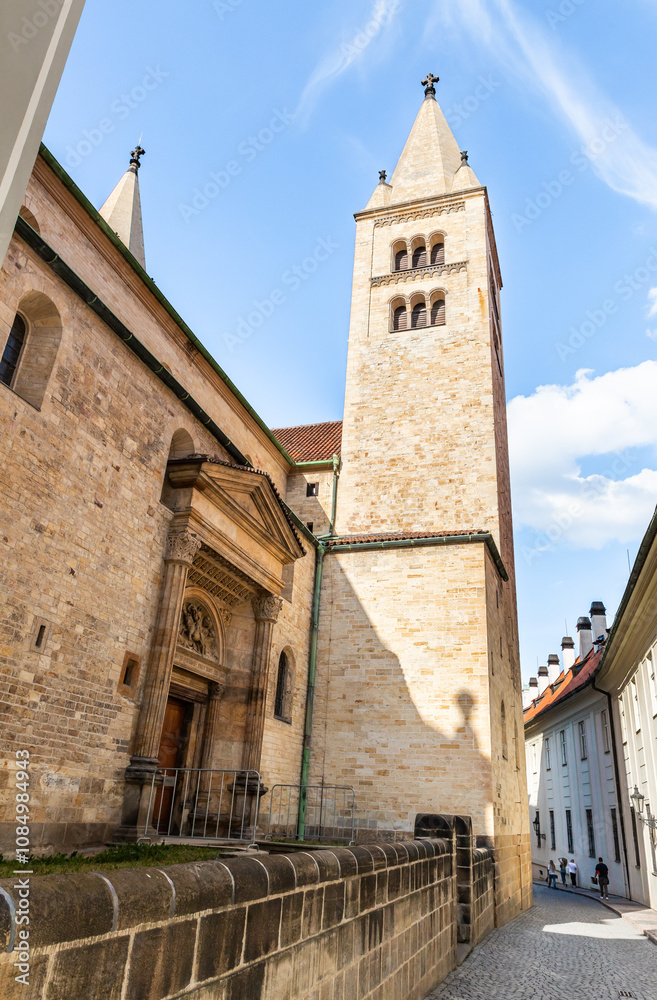 High tower of the St Georges Basilica in Third courtyard of Prague Castle near St Vitus Cathedral in Prague in Czech Republic High tower of the St Georges Basilica in Third courtyard of Prague Castle near St Vitus Cathedral in Prague in Czech Republic