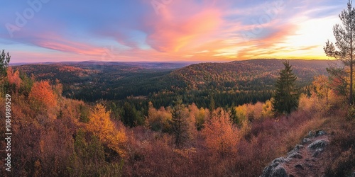 Breathtaking panoramic view of a vast autumn forest at sunset, with vibrant colors in the sky and trees.