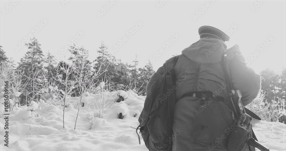 4K Re-enactor Dressed As German Wehrmacht Infantry Soldier In World War II Walking With Weapon In Winter Snowy Forest. Historical Re-enactment Black And White Video 4K Re-enactor Dressed As German Wehrmacht Infantry Soldier In World War II Walking With Weapon In Winter Snowy Forest. Historical Re-enactment Black And White Video