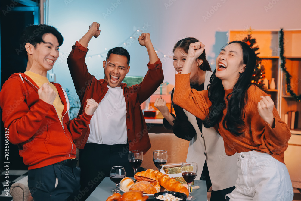 Group of young Asian man and women as friends having fun at a New Year's celebration, holding gift boxes standing by Christmas tree decoration, midnight countdown Party at home with holiday season. Group of young Asian man and women as friends having fun at a New Year's celebration, holding gift boxes standing by Christmas tree decoration, midnight countdown Party at home with holiday season.