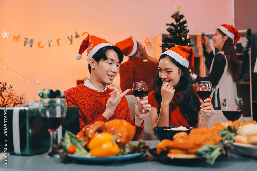Group of young Asian man and women as friends having fun at a New Year's celebration, holding gift boxes standing by Christmas tree decoration, midnight countdown Party at home with holiday season. Group of young Asian man and women as friends having fun at a New Year's celebration, holding gift boxes standing by Christmas tree decoration, midnight countdown Party at home with holiday season.