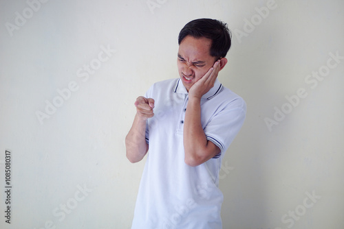 Man Expressing Displeasure with Stern Look and Pointing Gesture in Casual White Shirt