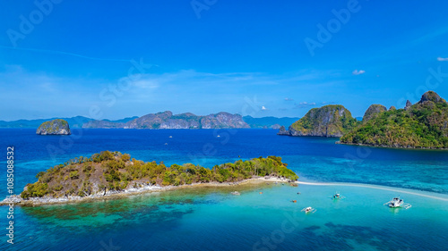 Aerail view of tropical exotic island sand bar separating sea in two with turquoise in El Nido, Palawan, Philippines.