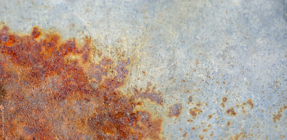 Fototapeta premium Macro shot of a rusted metal texture. Old weathered oxidized metal sheet. Corrosive rust on iron panel