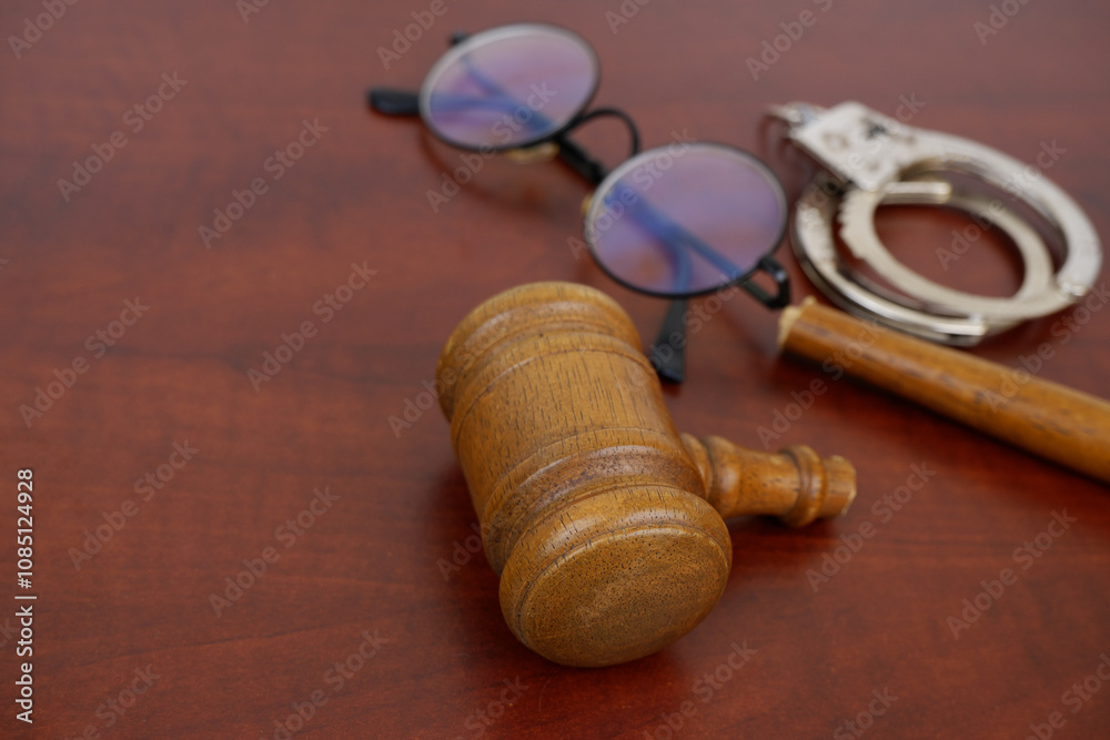 Handcuffs and broken judge gavel with eyeglasses, copy space for text. Injustice concept. Handcuffs and broken judge gavel with eyeglasses, copy space for text. Injustice concept.