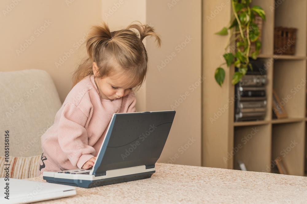 Lovely Toddler Exploring A Laptop In A Relaxed And Homely Setting. Smart Girl Learning New Things While Using Laptop In A Cozy Home Lovely Toddler Exploring A Laptop In A Relaxed And Homely Setting. Smart Girl Learning New Things While Using Laptop In A Cozy Home