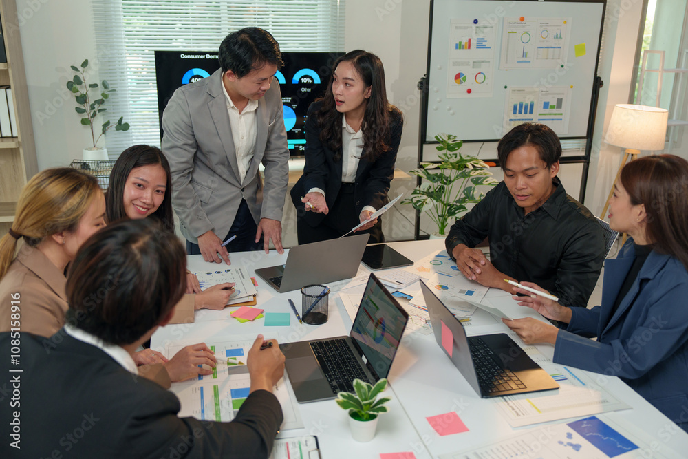 © crizzystudio - Financial analyst analyzes business finance reports on laptop and graph documents during corporate meeting discussions showing successful teamwork, business meeting ideas, marketing.