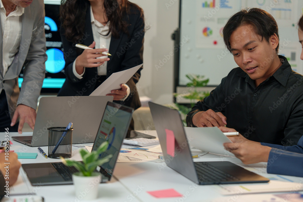 © crizzystudio - Financial analyst analyzes business finance reports on laptop and graph documents during corporate meeting discussions showing successful teamwork, business meeting ideas, marketing. © crizzystudio - Financial analyst analyzes business finance reports on laptop and graph documents during corporate meeting discussions showing successful teamwork, business meeting ideas, marketing.