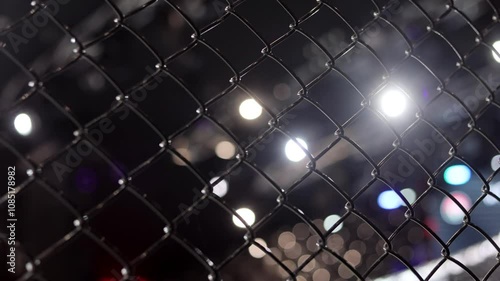 MMA cage arena lit by spotlights, Mixed martial arts fight night event
