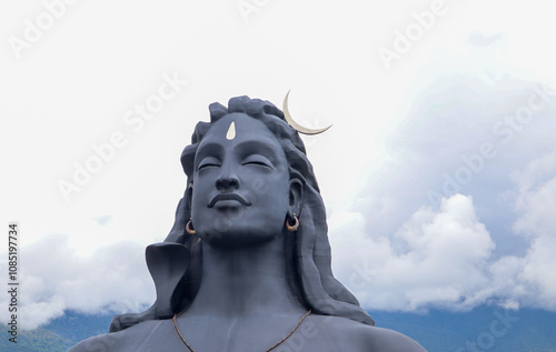 Canvas Print The magnificent sculpture 'Adi Yogi' or Lord Shiva in dark grey shades against the cloudscape at ISHA ashram near Coimbatore in Tamil Nadu, India