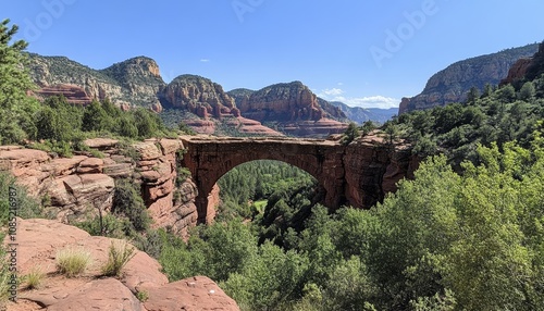 Stunning natural rock arch bridge at fryingpan church in sedona, arizona, with red rocks view photo