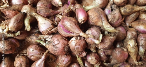 Pile of fresh red onions Sumenep or bawang merah Sumenep background Indonesia. Ready to cooked