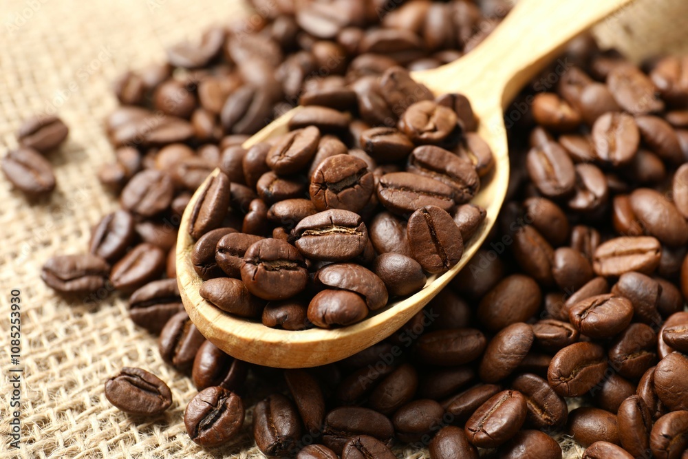 Spoon with coffee beans on burlap Spoon with coffee beans on burlap