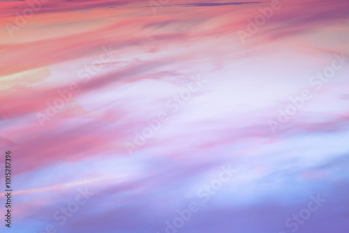 Twilight sky with effect of light in pastel pink, coral, orange, blue tones. Colorful sunset of soft clouds. Background