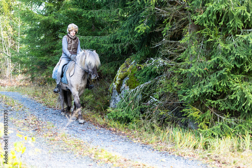 Icelandic horse riding. Rider has werewolf theme outfit photo