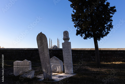 Tombstones in the garden of Muradiye Mosque in Edirne, one of the capitals of the Ottoman Empire, and Selimiye Mosque in the background photo