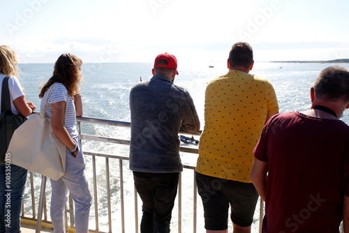 People enjoying the views while sailing with a ferry over the tidal mudflats of the Waddensea, The Netherlands photo