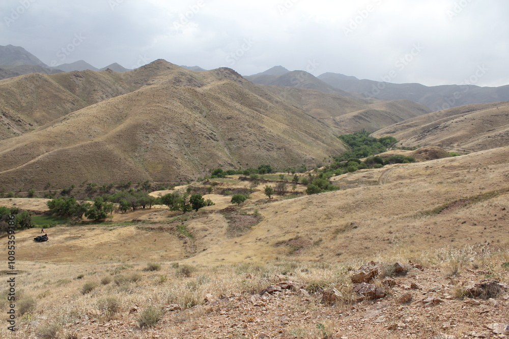 Expansive view of rugged mountain terrain under a clear sky, showcasing remote natural beauty. Expansive view of rugged mountain terrain under a clear sky, showcasing remote natural beauty.