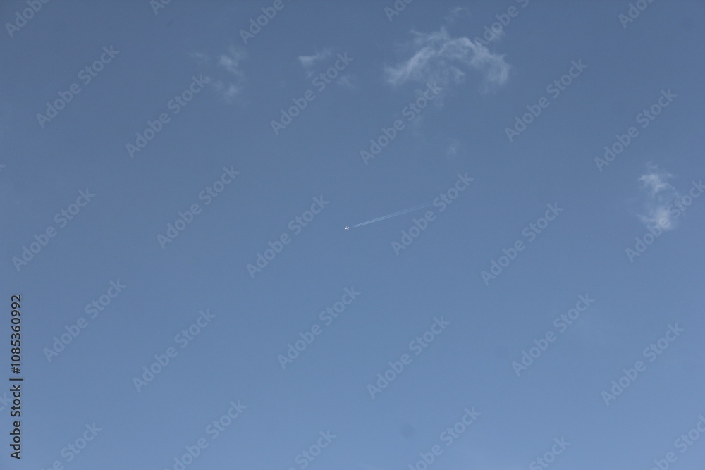 Clear blue sky with a single cloud, symbolizing simplicity, freedom, and openness in a natural setting. Clear blue sky with a single cloud, symbolizing simplicity, freedom, and openness in a natural setting.
