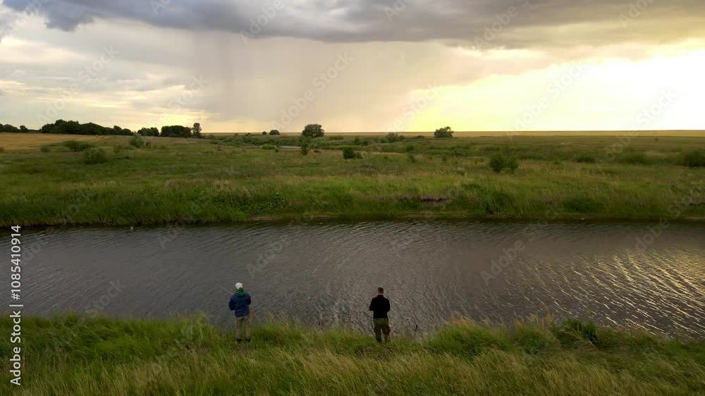Fishermen in the evening on the pond Fishermen in the evening on the pond