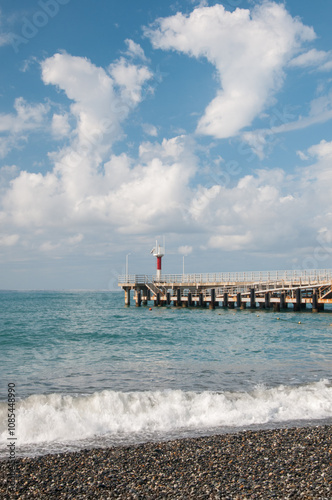 Morning view of Black Sea coastline in Dagomys resort with pier and beacon in the background, Russia photo